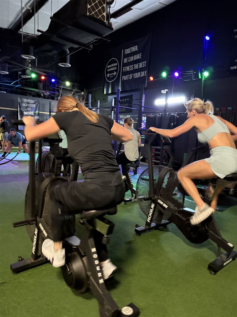 Members on ski ergs during conditioning class