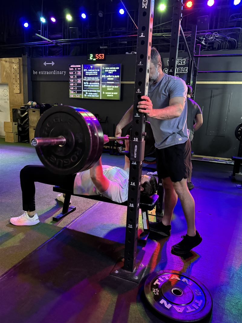 Members bench pressing during strength class